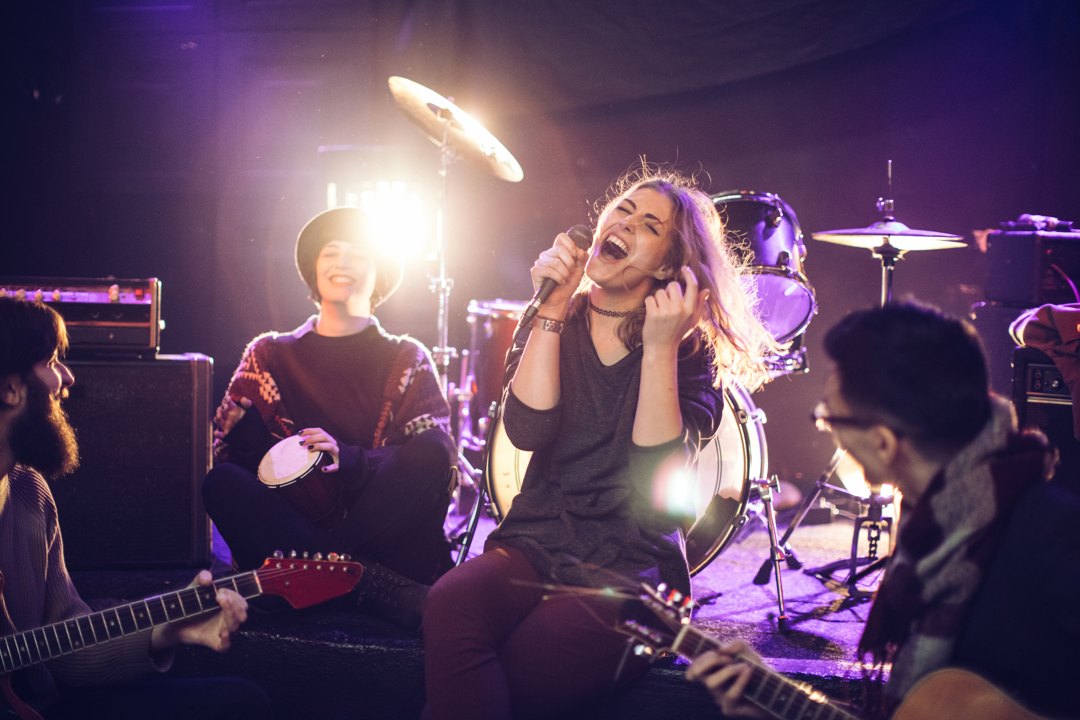 Group of friends practicing as a band, before the performance in the club.